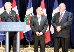 From left, Prime Minister Stephen Harper, AANDC Minister Bernard Valcourt and NWT Premier Bob McLeod answer questions on the devolution deal signed in Yellowknife on Mar. 11. (Photo by GNWT Executive)