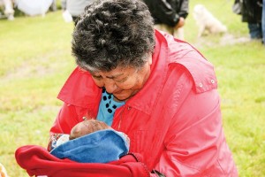 Fort McMurray elder Violet Clarke beams proudly at her newborn great-grandson, born in a teepee at midnight on Thursday evening, the eve of the Healing Walk.