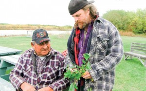 Fort Chipewyan resident Johnny Courtoreille (left) and University of Manitoba researcher Stephane McLachlan take willow samples as part of the community-based monitoring study looking to detect concentrations of contaminants like heavy metals and PAHs in wild foods frequently harvested by locals.