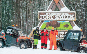 From left, Hanz Zundel, Ken Krahn and Phil Meagher celebrate in Fort Smith after a nine-hour quad ride from Fort McMurray on the winter road, all to raise money for the Centre for Hope homeless shelter.