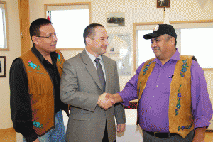 Glen Koropchuk, chief operating officer for De Beers, shakes hands with Yellowknives Dene Chief Ed Sangris of Dettah while N'Dilo Chief Ernest Betsina looks on.