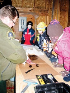 ENR officer Jerry Hordal teaches trapping skills to youth in the Take a Kid Trapping program.
