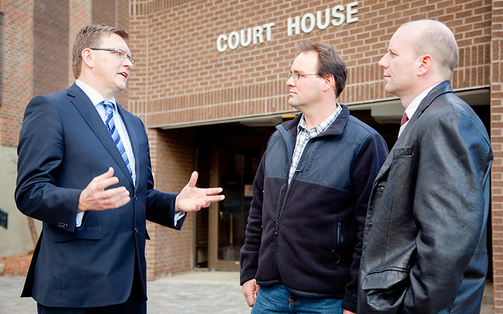 Land-rights lawyer Keith Wilson debriefs Alain and Brian Labrecque outside the court house after the trial against Baytex last Wednesday.
