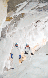 Wood Buffalo National Park staff Stu MacMillan and Sharon Irwin explore a wintery cave south of Fort Smith.