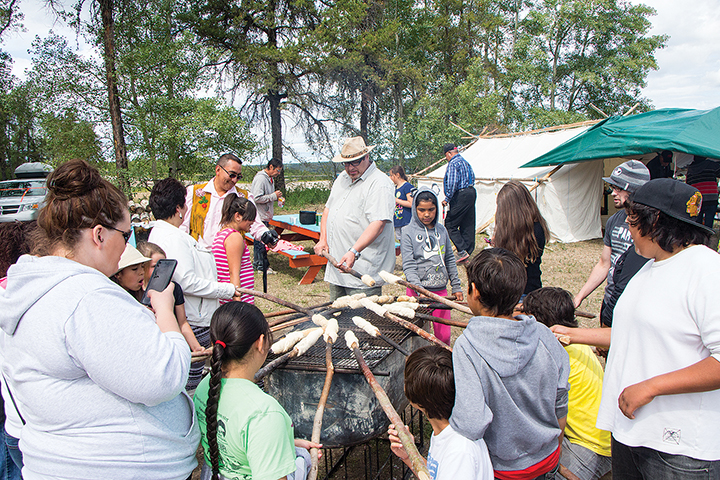 Maggie Sikeya’s bannock making station stays busy as crowds clamour for a tastes of her famous recipe.