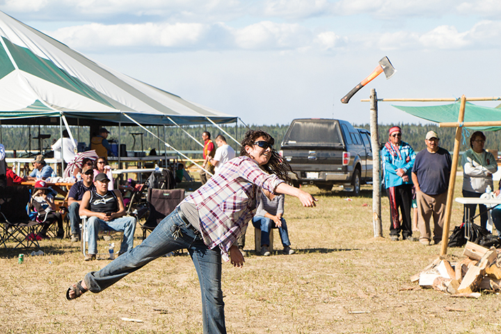 Cynthia Foote throws an axe during the adult traditional games.