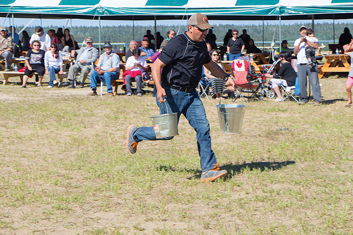 Darryl Bourke races through an obstacle course carrying heavy loads of water.