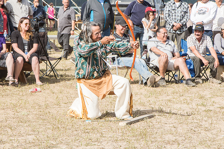 Henry Beaver Sr. takes aim during the Aboriginal Day bow and arrow contest in Fort Smith.