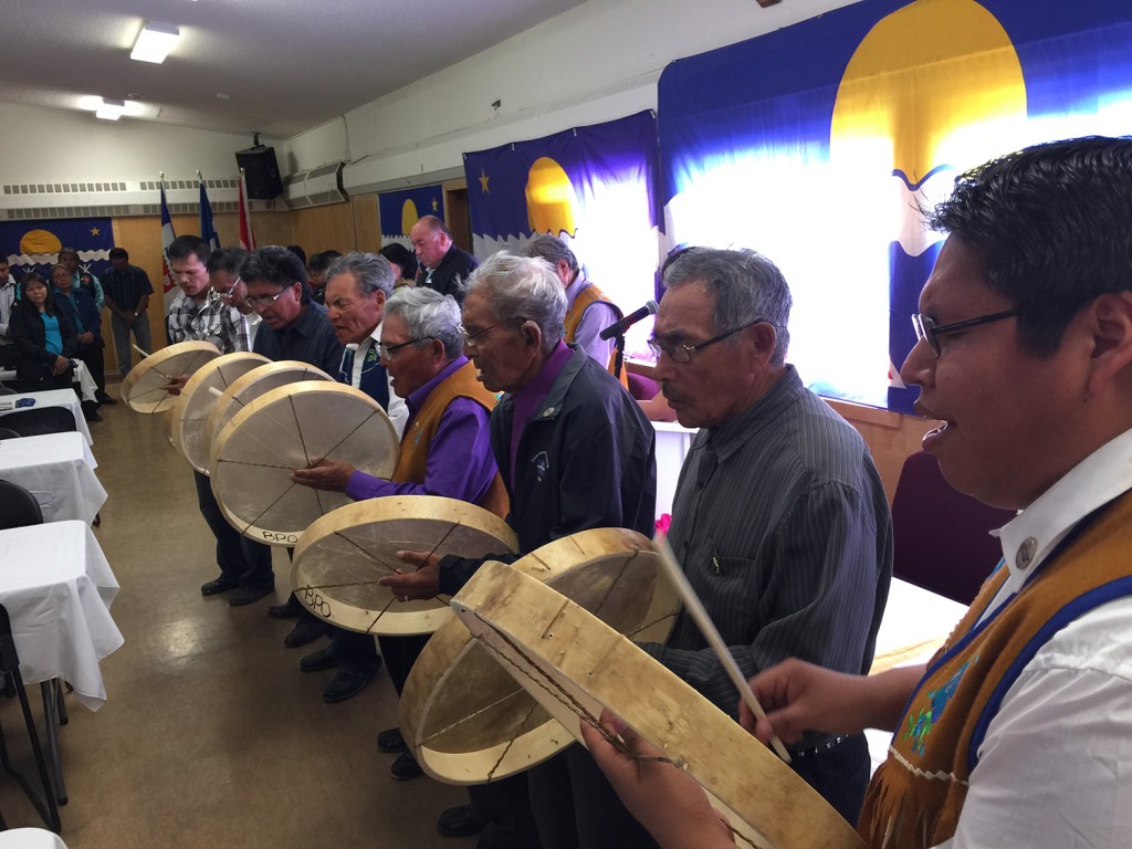 Members of the Tlicho community converged by air and water upon Behchoko on Aug. 6 to celebrate the 10th anniversary of the Tlicho Agreement, which established the Tlicho Government. Festivities included a feast, treaty payments, a tea dance and fireworks. At top, Chief Clifford Daniels of Behchoko greets attendees arriving by canoe; at bottom, drummers accompany a prayer song at the beginning of the feast.